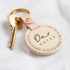 a wooden keychain with the date engraved on it