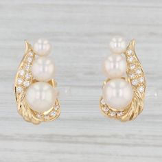 Gemstone Information: - Natural Cultured Pearls - Size - 4.1, 5.5, 6.6 - 6.7 mm Cut - Round Bead Shape Color - White - Natural Diamonds - Total Carats - 0.18ctw Cut - Round Brilliant Color - E - F Clarity - VS2 Metal: 18k Yellow Gold Weight: 5.5 Grams  Stamps: 18k Closure: Stick Posts & Butterfly Backs Measurements: 18.8 x 9.6 mm Each piece is thoroughly examined and refinished as needed by our professional jewelers, graded by our in-house GIA (Gemological Institute of America) Graduate Gemologi Aaa Quality Elegant Diamond Earrings For Anniversary, Akoya Pearl Wedding Jewelry Aaa Quality, Elegant Aaa Quality Diamond Earrings For Wedding, Fine Jewelry Pearl Earrings For Anniversary, Aaa Quality Diamond Earrings For Wedding, Aaa Quality Diamond Earrings For Anniversary, High Luster Pearl Earrings For Anniversary, Classic Bridal Earrings With 17 Jewels For Anniversary, 14k Gold Pearl Earrings With Diamond Accents For Wedding