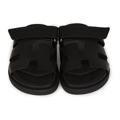 This pair of Cypre sandals are in Black calfskin and feature the iconic H and a velcro crossover strap. Origin: ItalyCondition: New and never wornAccompanied by: Hermes box, dustbags, ribbonSize: 34.5 EU Luxury Black Slides With Buckle Closure, Black Slip-on Sandals With Tang Buckle, Luxury Black Mules With Buckle Closure, Black Leather Double Strap Slides, Luxury Double Strap Sandals With Tang Buckle, Luxury Black Calf Leather Slides, Designer Leather Slide Sandals, Designer Double Strap Leather Sandals, Black Leather Double Strap Sandals