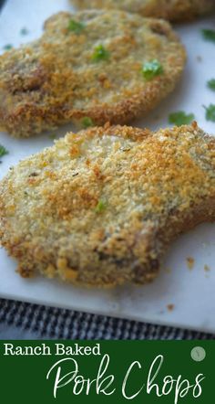 baked pork chops on a cutting board with parsley sprinkled over them