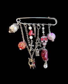 a bunch of charms hanging from a metal hook