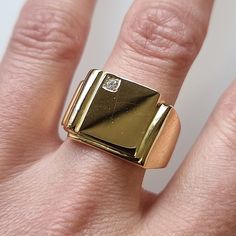 "A traditional signet ring with a rectangular face, set with single brilliant cut diamond, fully crafted in 9ct yellow gold and weighing a substantial 14.1 grams. Suitable for men or for women. Circa 1980's. Stamped \"18CT\". The face of the ring measures approximately 13.3mm from top to bottom. The approximate weight is 14.1 grams. Please note that the antique ring box pictured is for display purposes only. Thank you. Ring size S (UK) or 9 1/8 (US) - this ring can be adjusted in size in our workshop. Please get in touch to discuss sizing options and lead time. For UK to US ring size conversions we use www.ringsizes.co as our reference chart. CONDITION: In very good vintage condition, with some light surface wear commensurate with age. LAYAWAY: We happily offer layaway/deposits on the majo Modern Yellow Gold Rectangular Diamond Ring, Luxury Diamond Rectangular Signet Ring, Gold Rectangular Signet Ring Stamped 14k, Modern Gold Signet Ring With Single Diamond, Modernist Gold Signet Ring With Polished Finish, Modernist Yellow Gold Signet Ring For Anniversary, Classic Rectangular Diamond Ring For Gift, Classic Rectangular Diamond Ring As Gift, Modernist Rectangular Signet Ring With Polished Finish