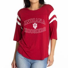 Elevate the style of your game day tee with this Indiana Hoosiers Abigail Jersey T-shirt. It features the team name and logo accentuated by contrast-color side stitching and sleeve stripes. A rounded hem gives this Indiana Hoosiers shirt a more comfortable fit and feel. Varsity T-shirt With Team Logo For Football Season, Collegiate Game Day T-shirt With Team Name, Casual Jersey T-shirt For Game Day, Varsity T-shirt With Team Name For College, Varsity Jersey Tops For Fan Gear, Game Day Sports Fan Crew Neck Top, Team Colors Tops For Game Day, Team-colored Tops For Baseball Season Fan Merchandise, Red Varsity T-shirt For Sports Season