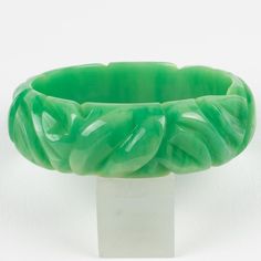 This is a gorgeous milky turquoise marble Bakelite carved bracelet bangle. It features a chunky domed shape with deep geometric carving all around. The color is an intense green marble tone with milky cloudy swirling. Measurements: Inside across is 2.63 in diameter (6.6 cm) - outside across is 3.19 in diameter (8.1 cm) - width is 0.88 in wide (2.2 cm) - The inner circumference of the bracelet is 8.16 in (20.72 cm).  Please see the measurements noted above in the description for the best approxim Carved Green Jade Bangle, Green Carved Bangle Bracelets, Green Carved Bangle Bracelet, Turquoise Marble, Green Marble, Bracelet Bangle, Bangle Bracelets, Marble, Bangles