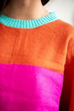 The Lucy Color Block Sweater showcases a vibrant color block design in bright pink, orange, and turquoise, adding a splash of bold color to your wardrobe. With its long sleeves and loose fit, it combines comfort with a playful, eye-catching style. Model is 5’4” wearing a size small Length of a small is 24.5" 52% Acrylic, 28% Polyamide, 20% Spandex Colour Block Jacket, Kate Moss Street Style, Color Blocking Design, Sweater Ideas, Outfit Options, Color Block Jacket, Color Block Design, Orange And Turquoise, Bold Color