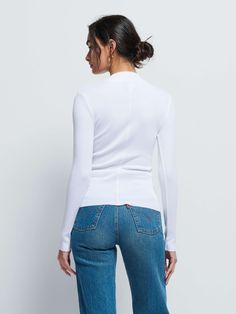 The perfect white, mock neck in our responsible Organic Rib. Use it as a layering piece or wear on it's own. (This one comes in White.) | Women's Gina Long Sleeve Top in White | Ethical Essentials White High Stretch High Neck Tops, High Stretch White High Neck Top, White Long Sleeve Turtleneck For Work, White Stretch Tops With Funnel Neck, White Mock Neck Top For Fall, White Stretch High Neck Turtleneck, Modern Turtleneck Top For Layering, Chic White Long Sleeve Turtleneck, White Funnel Neck Top For Layering