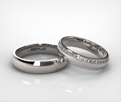 two white gold wedding rings with diamonds on the inside and outside, sitting side by side