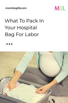 a woman sitting on the floor in front of a suitcase with her baby's diaper