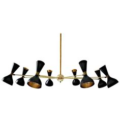 a brass and black chandelier with six lights hanging from it's center