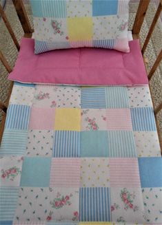 two baby cribs with pink, blue and yellow sheets