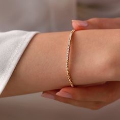 Add a touch of sophistication to your style with the Mon Cheri Diamond Bracelet. Crafted in 18K Gold, this bracelet features shimmering diamonds weighing 0.29 carats. The design is simple yet elegant, perfect for dressing up an outfit or adding a touch of glam to your everyday look. Timeless Gold Bracelet With Pave Setting, Timeless Pave Setting Bracelet Gift, Timeless Pave Setting Bracelets, Elegant Flexible Diamond Bangle Bracelet, Rose Gold Pave Setting Diamond Bracelet, Rose Gold Tennis Bracelet With Pave Setting As Gift, Timeless Tennis Bracelet With Pave Setting, Elegant Diamond White Gold Bracelet With Single Cut Diamonds, Timeless Bracelets With Pave Setting