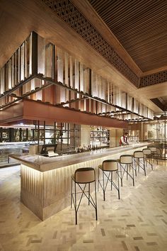 an empty bar with stools and tables