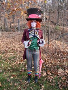 a clown dressed in costume standing on leaves