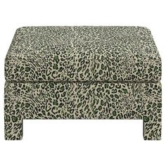 an animal print footstool sitting on top of a white floor