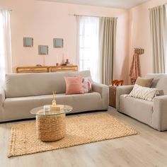 a living room filled with furniture and pink walls