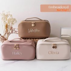 three personalized cosmetic bags sitting next to each other