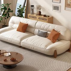 a living room with a white couch and coffee table in front of a large window