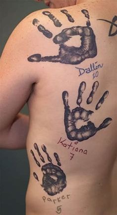 the back of a man with his hand and foot prints painted on it's chest