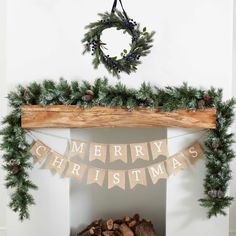 a fireplace decorated for christmas with garland and pine cones