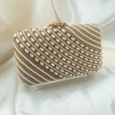 A beautiful gold colored embroidered clutch with bead work and pearl design. Size: 8 x 4 inches. - shoulder chain included Luxury Pearl Evening Bag For Party, Gold Pearl Evening Bag For Events, Gold Pearl Clutch For Parties, Gold Pearl Bags For Formal Occasions, Formal Gold Pearl Bags, Gold Pearl Party Clutch, Party Gold Pearl Clutch, Gold Evening Bag With Pearl Embroidery For Events, Luxury Pearl Clutch For Events