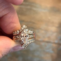 a person holding an engagement ring in their hand