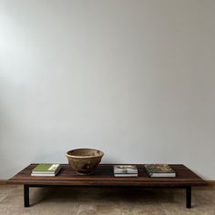 a wooden bowl sitting on top of a coffee table