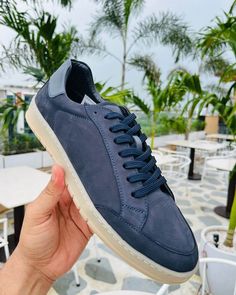 These Men's Navy Blue Sneakers offer a sleek blend of style and versatility. The premium leather upper in a rich navy hue pairs perfectly with the contrasting white sole for a modern, clean look. Designed for comfortable everyday wear, these versatile casual footwear options are perfect for everything from weekend outings to casual Fridays at the office. Experience the ideal balance of fashion and function with these essential sneakers. Sporty Navy Sneakers With Stitched Sole, Navy Casual Sneakers With Stitched Sole, Navy Casual Custom Sneakers With Rubber Sole, Casual Navy Sneakers With Contrast Sole, Navy Casual Sneakers With Plain Toe, Navy Casual Sneakers, Blue Sneakers With Contrast Sole, Navy Casual Custom Sneakers With Cushioned Footbed, Navy Leather Sneakers With Perforated Toe Box