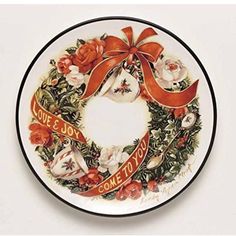 a plate with an orange ribbon on it that says love & joy come to us