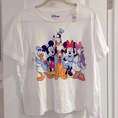 a t - shirt with mickey mouse and friends on it hanging from a door frame