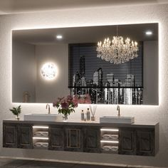 a bathroom with two sinks and a chandelier