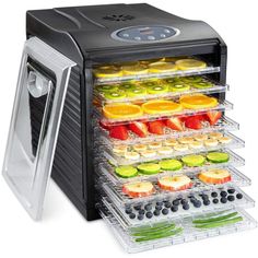 an electric food dehydrator with trays full of fresh fruits and vegetables