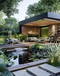 an outdoor living area with water features and plants in the foreground, surrounded by greenery