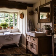 a bathroom with a tub, sink and mirror next to a window filled with potted plants