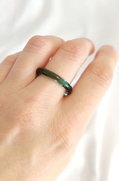 Explore the enchanting allure of handmade emerald green ring, crafted with durable borosilicate glass. The emerald green color full of energy will bring extra WOW to your outfit! Due to its artisanal shaping, the surface of the ring may exhibit slight irregularities, adding to its unique charm. Depending on the type and intensity of light, the ring showcases shades of green ranging from emerald to vibrant or subtly muted tones with a hint of gray. This bit of magic enclosed in glass will add uniqueness to your jewelry collection. Elevate your style with this captivating piece that captures the essence of nature's elegance. Each ring is a one-of-a-kind creation, ensuring you adorn a truly distinctive accessory. All the products are packed safely in the beautiful paper box and will be a perf Emerald Green Ring, Nature Inspired Rings, Green Ring, Glass Ring, Beautiful Paper, Muted Tones, Color Full, Glass Rings, Ring Unique