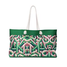 a green and pink bag with an abstract design on the front, featuring white handles