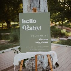 a sign that is on top of a wooden easel in front of a tree