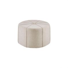 a white ottoman sitting on top of a white floor