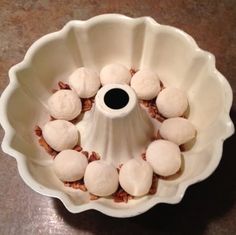 a white bowl filled with food on top of a table