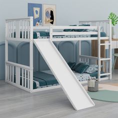 a white bunk bed with a slide in the middle