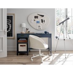 a white chair sitting in front of a desk with a clock on the wall behind it