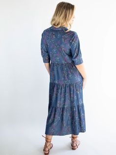 It’s no wonder that our Rebecca Midi Dress has been given over 2,000 FIVE STAR reviews! This all-time best seller is flattering for any shape and is super easy to wear - and now we have this Rebecca Tiered Dress made from a chambray fabric with a purple wisteria floral print! It’s fitted at the top with a buttoned bodice and a winsome empire waist. The high-low hem is ready to show off your favorite sandals, boots or heels. The rest of this tiered, chambray dress flows in a relaxed fit that keep Purple Wisteria, Chambray Fabric, Purple Midi Dress, Chambray Dress, Colorful Boho, Bohemian Clothes, Tiered Dress, Wisteria, High Low Hem