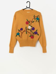 Vintage embroidered mustard yellow jumper, floral design. This stunning 80s/90s jumper features a stunning and colourful floral design on the front, a crew neck and long sleeves. Made from a soft, mid-weight wool blend.  Our recommended size: Small to medium Label says: Free Condition: Very good Material: 70% acrylic, 30% wool Measurements in inches: Pit to pit: 18.5 Shoulders: 18 Front length: 22.5 Back length: 23 Sleeve length: 23 Hem unstretched: 11 Hem stretched: 15 We recommend that you com Long Sleeve Sweater With Multicolor Embroidery For Fall, Fall Long Sleeve Sweater With Multicolor Embroidery, Fall Sweater With Multicolor Embroidery And Long Sleeves, Fall Floral Embroidered Crew Neck Sweater, Retro Yellow Long Sleeve Sweater, Retro Embroidered Crew Neck Sweater, Vintage Embroidered Fall Sweater, Vintage Brown Sweater For Spring, Yellow Vintage Winter Tops