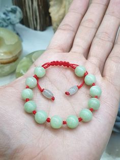 12 pieces of special, semibarouque shaped, cantaloupe green Jade beads, 9.5 mm size, were put together to make this beautifully handcrafted, adjustable Red Thread woven bracelet. A pair of smaller, barrel-shaped, translucent Jade beads were used for the adjusters. All Jade bead components are Type A natural Jadeite (non-bleached, non-dyed, non-treated materials), semitranslucent, glossy, finely polished. Good health, wealth, prosperity & good luck . Base/ Fit size are 14 cm and 17 cm, adjustable. For customers with much bigger fist and wrist, you can send us a direct message after your payment so we can customized the size before shipping. Price indicated is for 1 bracelet only. Handmade Red Jade Bracelets, Adjustable Red Jade Bracelet, Green Braided Bracelets With Sliding Knot And Round Beads, Handmade Green Braided Bracelets With Round Beads, Green Beaded Bracelets With Sliding Knot As Gift, Adjustable Light Green Bracelets As Gifts, Adjustable Light Green Bracelet As A Gift, Adjustable Light Green Bracelets For Gift, Jade Beaded Adjustable Bracelet