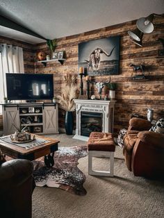 a living room filled with furniture and a flat screen tv on top of a wooden wall