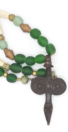 PEINTURE DE LOBI Tribal necklace with LOBI pendant,Bone Beads and green powder glas beads  . . . antique BONE beads,with carved pattern,about 45-50 years old, from Westafrica, various brass/messing beads from Westafrica ("lost form"), green KROBO beads (light - and dark green) made from powderglas, from Westafrica, 2 dark green beads made from antique glas, facet cut,from India, . . . a dream-beautiful pendant of the LOBI  (PROTECTION PENDANT) Total lenght incl. pendant : about 32.28 inch Pendan Unique Green Necklace With 108 Beads, Green Spiritual Beaded Necklace With Spacer Beads, Traditional Green Necklace For Meditation, Spiritual Green Beaded Necklace With Spacer Beads, Traditional Green Necklace For Healing, Amulet Style Beaded Necklace With Spacer Beads As Gift, Unique Hand-strung Green Beaded Necklaces, Recycled Glass Beaded Necklaces With Round Beads As Gift, Recycled Glass Beaded Necklaces As Gifts