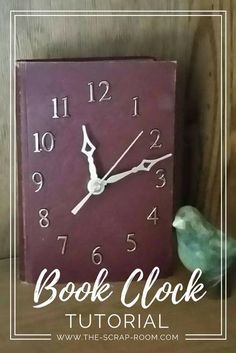 a purple clock sitting on top of a wooden table next to a green toy bird