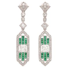 True elegance apparently can be summed up in a pair of earrings! These platinum stunners feature two extremely fine natural princess cut diamonds graded at G-VS and weighing 1.46cttw set between rows of perfectly matched vibrant green emeralds weighing 0.62cttw and accented by surrounding melee diamonds for another 0.44cttw, all coming together to create an absolutely beautiful pair of earrings. The pushback closures deliver maximum comfort and security for the wearer. The earrings measure just over 1.5" in length and weigh 8.8 grams total. Elegant design meets exceptional materials in this truly spectacular pair of earrings that bring together new construction with a vintage feel. These earrings are currently retailing for $12,750.00