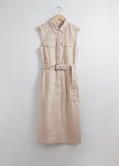 Sleeveless linen midi dress with a workwear-inspired finish, featuring utility pockets and an eyelet-detailed buckle belt. Traced with concealed snap button closures.• Slim fit• Turn-down collar• Large patch pocket at the legs• Chest patch pockets• Length of dress:122.5cm / 48.2" (EU 36 / UK 8 / US 4) Summer Style Guide, Linen Midi Dress, Summer Fashion Dresses, Buckle Belt, Fashion Story, Midi Dress Sleeveless, Shirtdress, Pure Linen, Workwear Dress