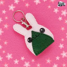 a crocheted keychain with a green and white christmas tree on it