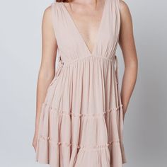 This Deep V Swing Dress Showcases An Alluring Silhouette With Beautiful Ruffle And Lace Up Side Cut Out Details. Perfect For A Beach Or Boho Look, This Dress Will Make You Stand Out In Any Occasion. Self 100% Rayon Breezy Mini Dress For Beach Cover-up, V-neck Sundress For Summer Outings, Tiered Dress For Beach Season Day Out, Chic V-neck Beach Dress For Summer Outings, Sleeveless Summer Boho Dress For Brunch, Sleeveless Boho Summer Dress For Brunch, Tiered Beachwear Dress For Day Out, Chic V-neck Sundress For Summer Outings, Summer Tiered Beach Dress